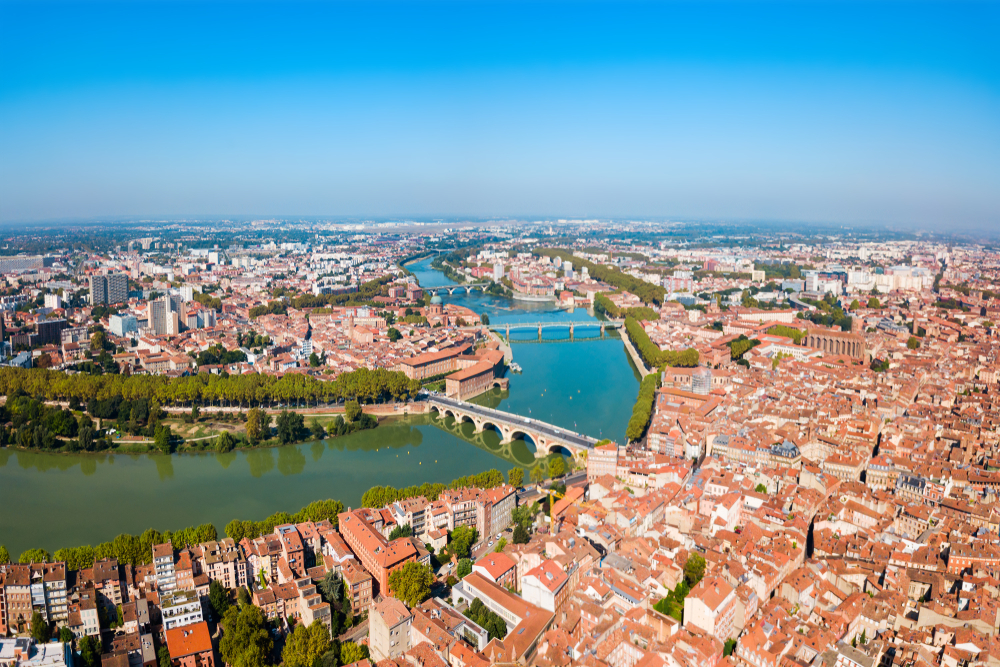 Toulouse en de rivier de Garonne en zijn bruggen gezien van bovenaf op een klaar blauwe dag