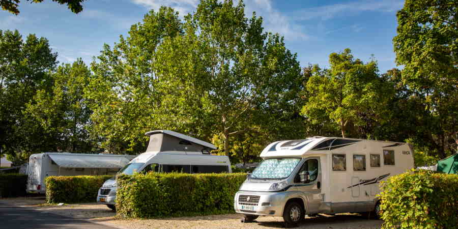 campers op kampeerplaatsen meet daartussen lage, rechte struiken op Camping de Châlons-en-Champagne